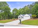 A beautifully landscaped yard leads up to this home, complete with an American flag proudly displayed at 40 Kelsey Way, Palmetto, GA 30268