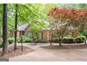 Attractive home showcasing a brick facade, lush greenery, and a curved driveway at 260 Emerald Lake Dr, Fayetteville, GA 30215
