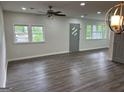 Open living room featuring laminate floors, neutral walls and ample natural light at 132 N Johnson St, Bowdon, GA 30108