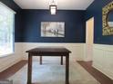 Dining room boasting dark blue walls, chair rail molding, and stylish light fixture at 4832 Batiste, Acworth, GA 30101