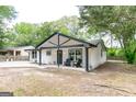 Inviting home featuring a covered front porch and a spacious front yard at 6532 Voyles Dr, Riverdale, GA 30274
