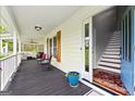 Inviting front porch with an open door, outdoor seating, and view of an interior staircase at 614 Highway 85 Conn, Brooks, GA 30205