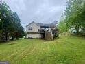 Expansive backyard featuring a large deck and lush green lawn, great for outdoor enjoyment at 103 Manx Dr, Grantville, GA 30220
