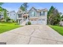 Charming home with a two-car garage, white stairs, and a manicured front yard at 103 Manx Dr, Grantville, GA 30220