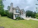Well-maintained two-story home boasting a lush green lawn and convenient two-car garage at 103 Manx Dr, Grantville, GA 30220