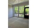 Covered patio featuring a screen door, railing, and textured concrete flooring at 3708 Cheswolde Ave # 95, Powder Springs, GA 30127