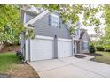 A two-story home featuring a two car garage, a stone facade, gray siding, and a well-manicured lawn at 3313 Bethesda Ter, Acworth, GA 30101