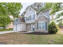 Two-story home showcasing stone accents, gray siding, a well-manicured lawn, and a convenient two-car garage at 3313 Bethesda Ter, Acworth, GA 30101