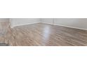 Wood-look flooring creates a seamless and stylish design throughout the living spaces and adjoining rooms at 8069 Louis Dr, Locust Grove, GA 30248