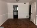 Dining room with hardwood flooring and doorway view into the kitchen at 1023 Falling Water Se Dr, Smyrna, GA 30080