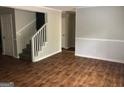 Open living room showcasing hardwood floors, stairs to the second floor, and ample space at 1023 Falling Water Se Dr, Smyrna, GA 30080