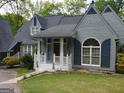 Charming home with a well-manicured lawn, inviting front porch, and classic architectural details at 145 E Lake Dr, Mountain Park, GA 30075
