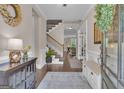 Inviting foyer with hardwood floors, staircase, elegant decor, and views into adjacent living spaces at 335 Discovery Lake Dr, Fayetteville, GA 30215