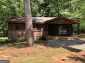 Exterior front elevation of a one story wood clad home with brick foundation and support columns at 6154 Green Acres Sw Dr, Covington, GA 30014