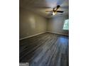Bedroom with modern vinyl flooring and a ceiling fan providing comfort at 2204 Liberty Sw Ln, Conyers, GA 30094