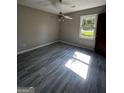 Bedroom featuring a ceiling fan, bright window, and modern vinyl flooring at 2204 Liberty Sw Ln, Conyers, GA 30094