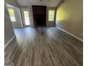 Inviting living room featuring new floors and a brick fireplace at 2204 Liberty Sw Ln, Conyers, GA 30094