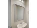 Clean bathroom with a stylish mirror, vanity sink, and neutral wall color at 8714 Lakeview Commons # 48, Jonesboro, GA 30238