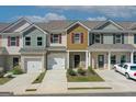 Lovely exterior view of townhomes with garages, brick facade, and inviting landscaping at 8714 Lakeview Commons # 48, Jonesboro, GA 30238