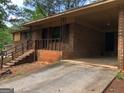 Charming brick home with a covered carport and front entrance at 7225 Pineneedle Sw Dr, Covington, GA 30014