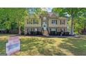 Charming home featuring brick and siding, complemented by a well-manicured front yard at 1401 Aberdeen Ct, Mcdonough, GA 30253
