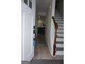 Bright entryway hall with staircase leads into the home's living area with sleek flooring at 2566 Summit Cove Dr, Duluth, GA 30097