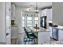 Bright kitchen with granite counters, stainless steel appliances, and breakfast bar seating by the window at 2566 Summit Cove Dr, Duluth, GA 30097