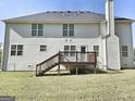 Back of a two-story home with white siding and a wooden deck at 247 Water Oak Ln, Jonesboro, GA 30238