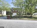Brick and stone home with a two-car garage and a well-maintained lawn at 247 Water Oak Ln, Jonesboro, GA 30238