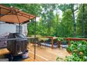 Wooden deck featuring a built-in grill and a view of the backyard at 3644 Graycliff Rd, Snellville, GA 30039
