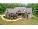 Charming brick home featuring manicured landscaping and a welcoming front porch at 1233 Butler Bridge Rd, Mcdonough, GA 30252