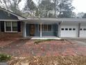 A beautiful home with a brick walkway, a blue facade, and a front porch at 1329 Springwood Nw Dr, Conyers, GA 30012