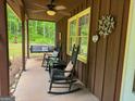 Inviting covered porch with ceiling fan and rocking chairs offers a relaxing outdoor space at 712 Honeysuckle Ln, Temple, GA 30179