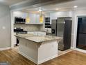 Bright kitchen features granite counters, stainless steel appliances, and a functional center island at 1607 Hillview Ave, Jonesboro, GA 30236