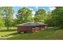 Brick ranch home with well-maintained lawn and mature trees at 292 S Prospect Ave, Waco, GA 30182