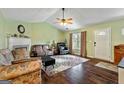 Inviting living room featuring a fireplace, ceiling fan, and hardwood floors at 105 Meadow Spring'S Ct, Locust Grove, GA 30248