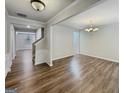 Elegant dining room showcasing wood floors and a classic chandelier with views to the living room at 376 Layfield Dr, Jonesboro, GA 30238