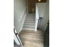 Stairway featuring neutral colors, newel posts and hardwood flooring at 140 Clover Valley Dr, Covington, GA 30016