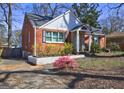 Charming brick home shows off its mature landscaping and inviting exterior at 3464 Wren Rd, Decatur, GA 30032