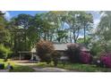 View of the home's exterior showing the carport, driveway, and mature landscaping at 402 Emmett St, Riverdale, GA 30274