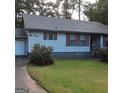 Charming single-story home with well-maintained lawn and classic architectural details at 402 Emmett St, Riverdale, GA 30274