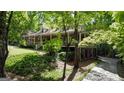 Beautiful brick home with a covered porch, surrounded by lush greenery at 31 Butler Bridge Dr, Mcdonough, GA 30252