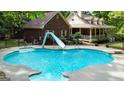 Beautiful in-ground pool with slide and fenced-in backyard, perfect for summer fun at 31 Butler Bridge Dr, Mcdonough, GA 30252