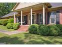 Charming single-story home with a brick facade and covered front porch with columns at 109 Old Virginia Cir, Jonesboro, GA 30236
