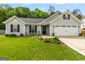 Beautiful gray home with a well-manicured lawn, dark shutters, and a 'Welcome' sign on the front porch at 12 Connie Trl, Grantville, GA 30220