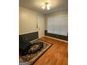 Entryway features hardwood floors, neutral-toned walls with black accents, and a window with wooden blinds at 1129 River Green Ct, Mcdonough, GA 30252