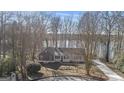 Exterior view of home surrounded by mature trees, front porch and landscaping at 84 Contour Dr, Stockbridge, GA 30281