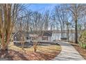 Single story home featuring mature trees, front porch and landscaping at 84 Contour Dr, Stockbridge, GA 30281