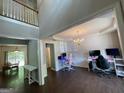 A vibrant room featuring a loft space, hardwood floors, gaming chairs, and modern décor at 616 Wallnut Hall Tl, Woodstock, GA 30189