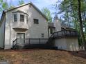 Back exterior view of a two story home with a wooden deck and stairs at 760 Swan Ln, Canton, GA 30115